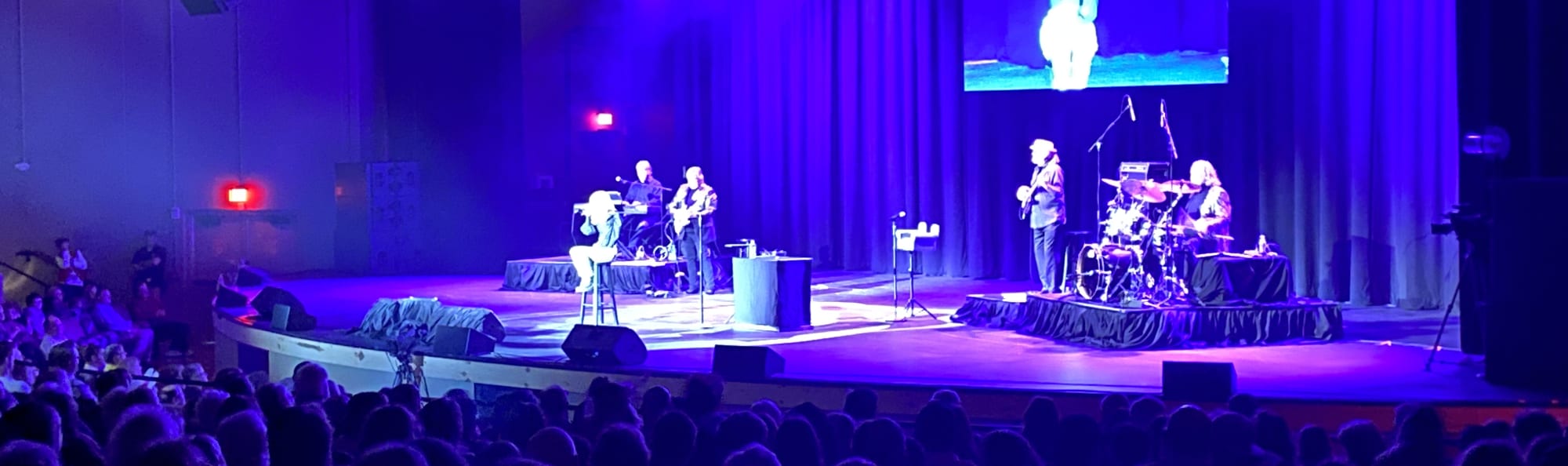 signer on stage in chair washed out by the lights Santa Barbara